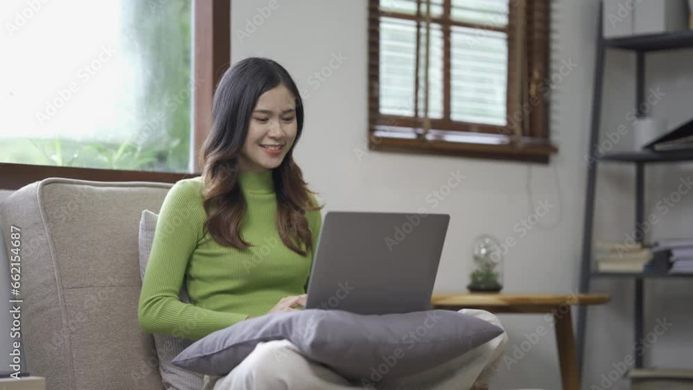 Attractive Asian woman working, surfing the internet, using laptop device, working online from home at living room on floor with cheerful, happy expression. Attractive Asian woman working, surfing the internet, using laptop device, working online from home at living room on floor with cheerful, happy expression.