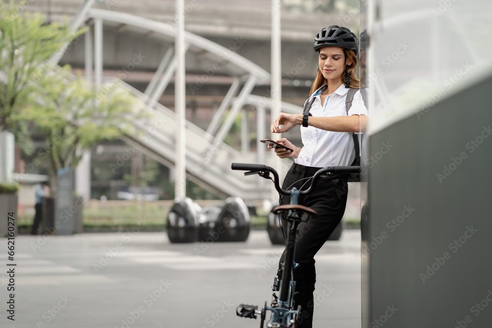 Eco friendly, businesswoman ride bicycle in urban to reduce carbon footprint. Beautiful woman environment preservation person commuting with bicycling. Cycling, alternative transport for clean energy.