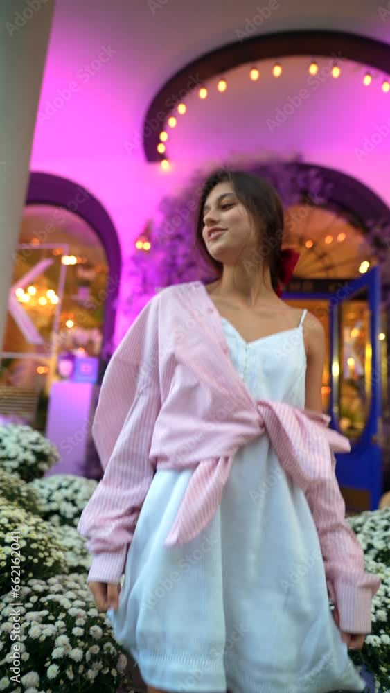 A young woman immersed in the romantic beauty of a garden's purple blooms. A young woman immersed in the romantic beauty of a garden's purple blooms.