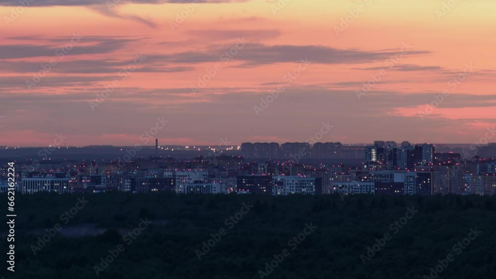 Panorama of the evening city with the light coming on in the windows of houses, timelapse Panorama of the evening city with the light coming on in the windows of houses, timelapse
