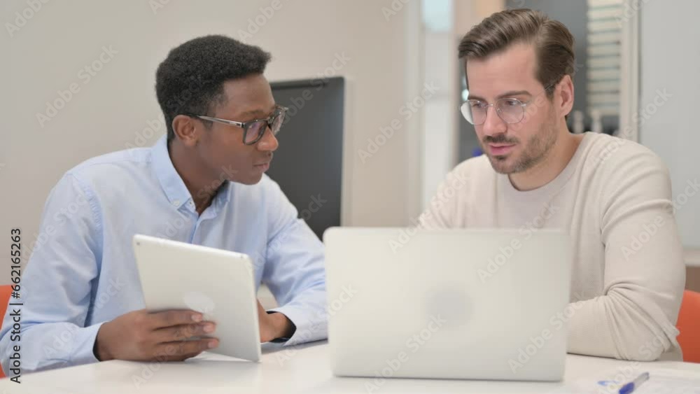 Business People Working on Tablet and Laptop in Office Business People Working on Tablet and Laptop in Office
