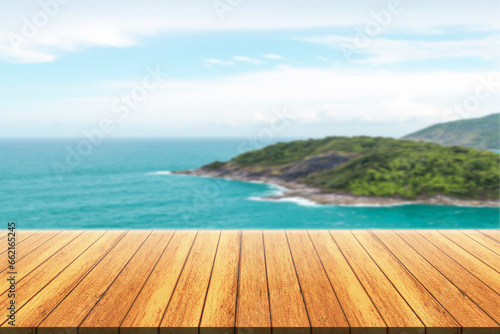 Empty wooden floor for product display montages with sea and mountain background. 