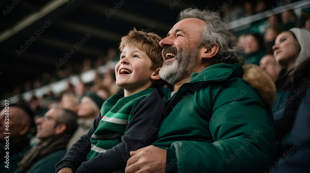 Irish father and son in stands, filled with enthusiastic supporters of rugby or football team wearing green clothes to support national sports team - obrazy, fototapety, plakaty 