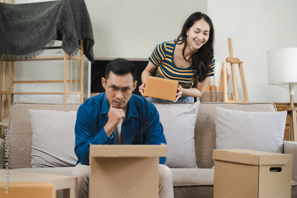 young couple helps put things in boxes and prepares to move to a new house. young couple helps put things in boxes and prepares to move to a new house.