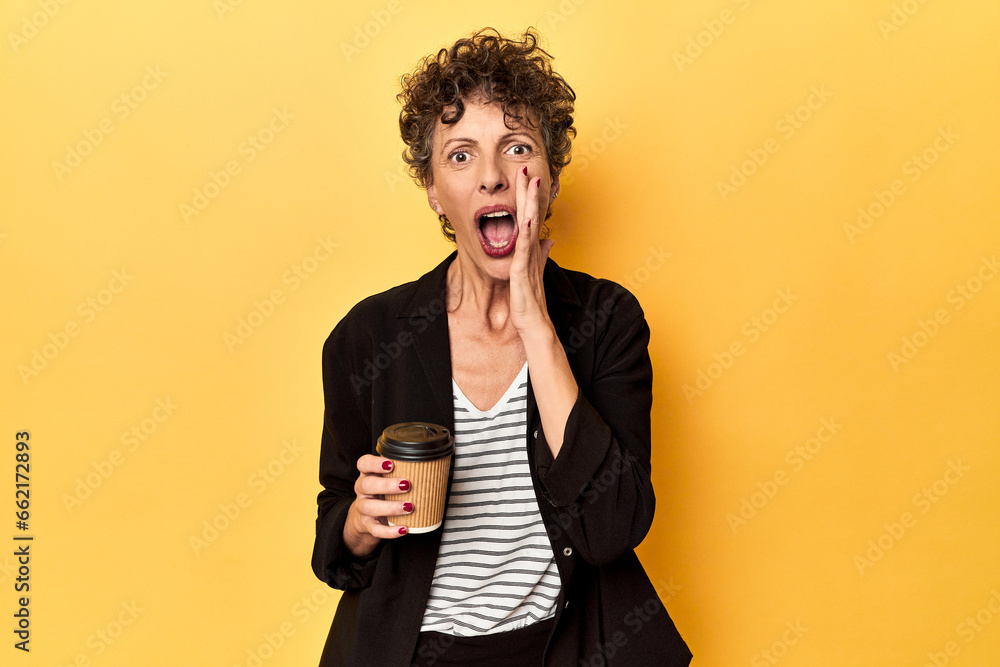 Businesswoman holding takeaway coffee on yellow shouting and holding palm near opened mouth. Businesswoman holding takeaway coffee on yellow shouting and holding palm near opened mouth.