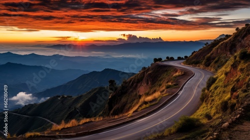 A road with a stunning sunset over the mountains © Cloudyew