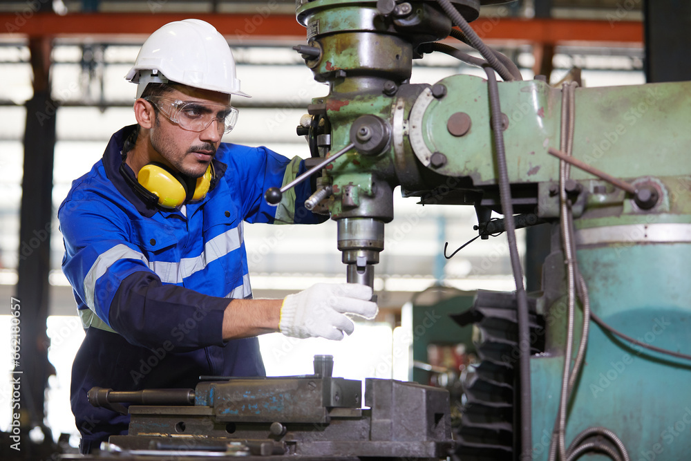 factory worker or technician checking and control lathe machine in factory factory worker or technician checking and control lathe machine in factory
