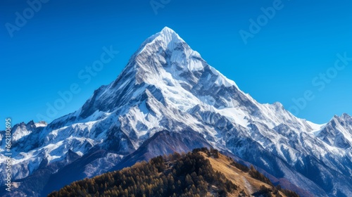 A snow-capped mountain peak against a clear sky