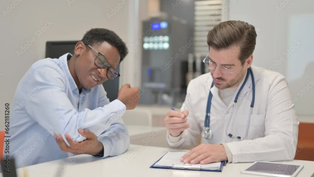 Man with Elbow Pain Consulting Male Orthopaedic Doctor Man with Elbow Pain Consulting Male Orthopaedic Doctor