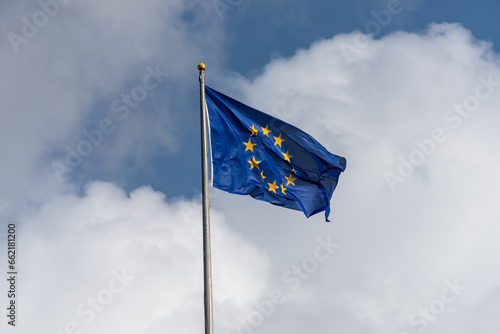 Europafahne im Wind flatternd vor blauem Himmel mit Wolken photo