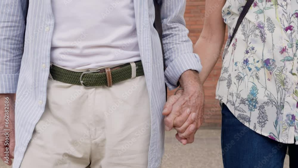 Close-up The hands of an anonymous elderly person walk hand in hand, supporting each other to walk steadily. Expressing love for each other until old age. Men and women walk hand in hand. Close-up The hands of an anonymous elderly person walk hand in hand, supporting each other to walk steadily. Expressing love for each other until old age. Men and women walk hand in hand.