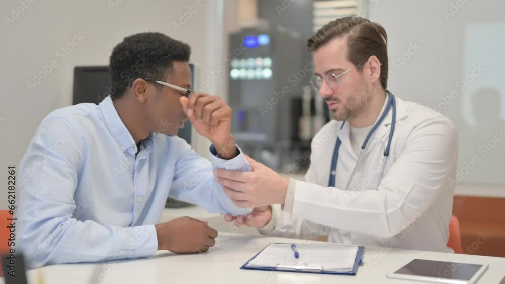 Orthopaedic Doctor Checking Elbow of African Man Orthopaedic Doctor Checking Elbow of African Man