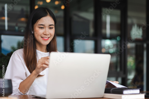 Businesswomen use laptop to meeting in video call and reading data while working in outside office