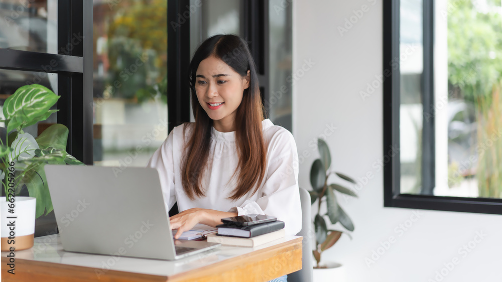 Businesswomen using laptop to typing financial data and working about new startup in outside office Businesswomen using laptop to typing financial data and working about new startup in outside office