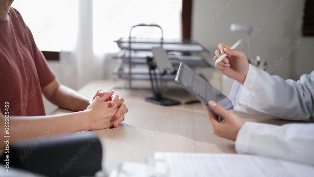 Asian patient women with anxiety explaining about psychological health problem to doctor while female psychologist writing notes on tablet and counseling about medicine and mental health therapy - obrazy, fototapety, plakaty 