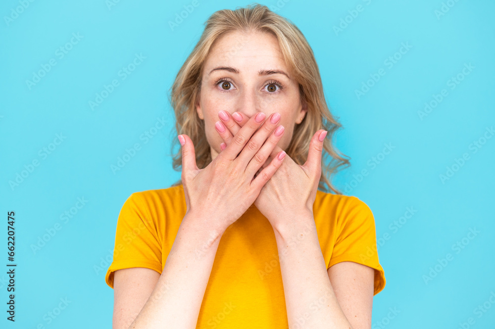 Portrait of surprised young woman. Don't want to tell secret - obrazy, fototapety, plakaty 