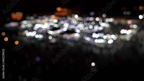 Jemma el Fnaa square in Marrakesh, Morocco at night is a vibrant market square with many people and motion. Out of focus and bokeh video done on purpose.