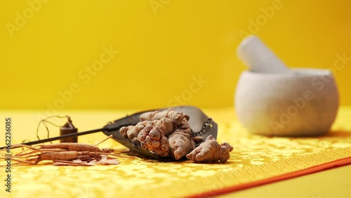 Traditional Chinese medicine Notoginseng against a golden background photo