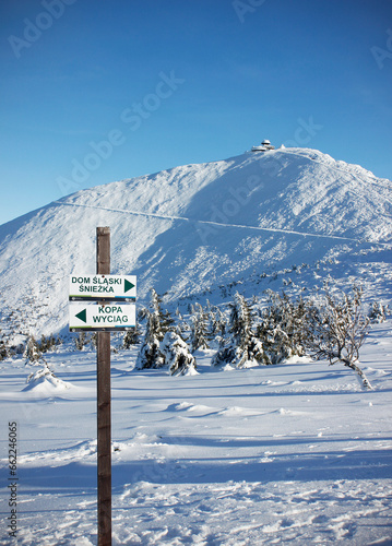 The snow-capped peak of the Snezka Mountain in the Krkonose Mountains on a sunny day during winter. The highest mountain of the Giant mountains, Poland, Czech Republic, Europe