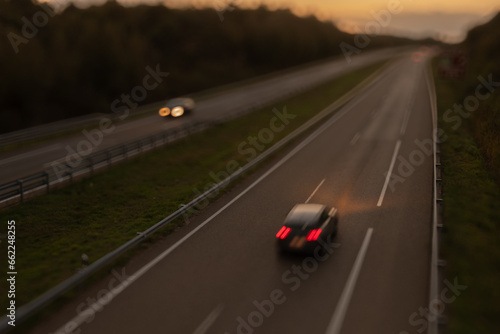 Blurred photography of cars motion in a highway at sunset © VicVaz