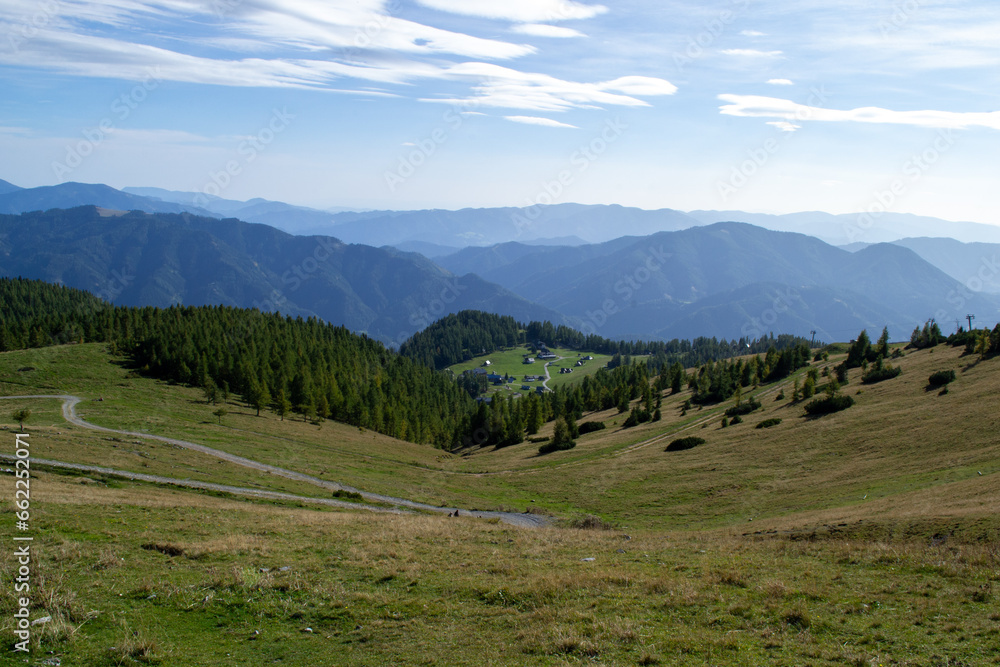 Alpine green meadows and forests on an autumn sunny day Alpine green meadows and forests on an autumn sunny day