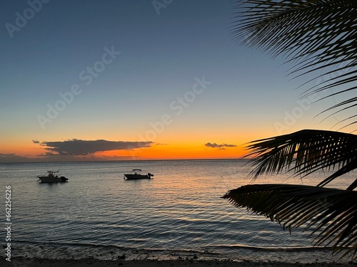 Dramatically colorful sky after sunset over Indian Ocean in Mauritius