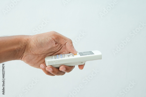 Hand holding air condition wireless remote control isolated on white with clipping path.