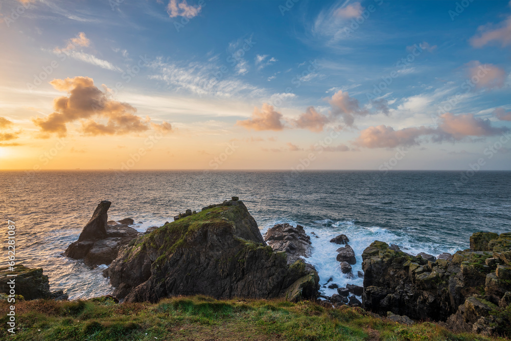 Beautiful dramatic Summer dawn over Lizard Point in Cornwall UK with lovely glowing sky and clouds