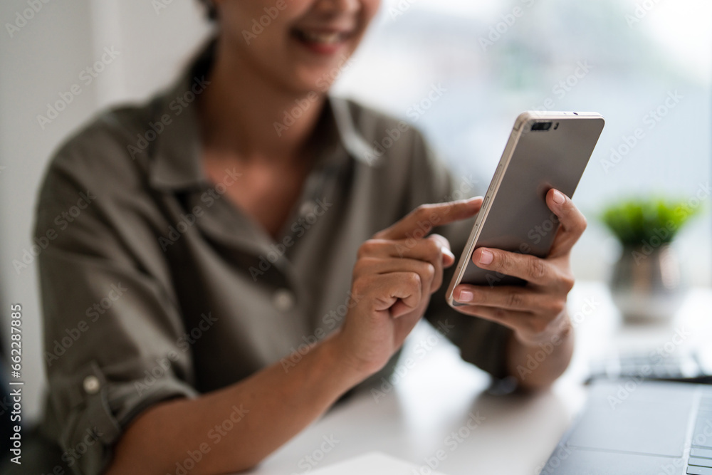 Asian casual businesswoman use smartphone to checking growth finance report of new startup project Asian casual businesswoman use smartphone to checking growth finance report of new startup project