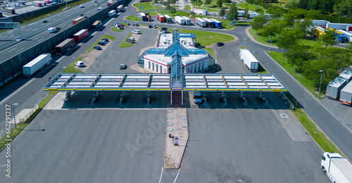 Aerial view of highway rest area with restaurant and large car park for cars and trucks. Highway A10 in Germany 