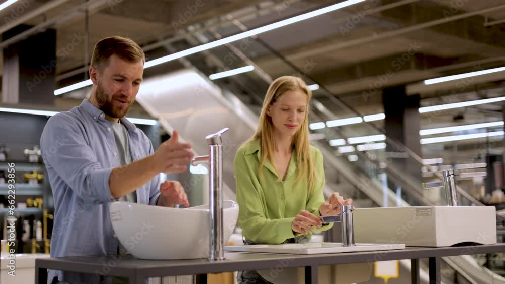 Couple at the building market looking for sink into their bathroom Couple at the building market looking for sink into their bathroom