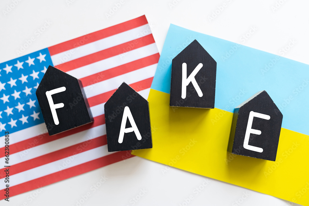 A Fake News pin badge pictured over the flag of the United States of America. A Fake News pin badge pictured over the flag of the United States of America.