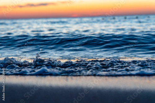 Ocean waves crash at a Pacific Ocean sunset