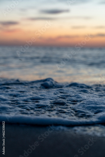 Ocean waves crash at a Pacific Ocean sunset