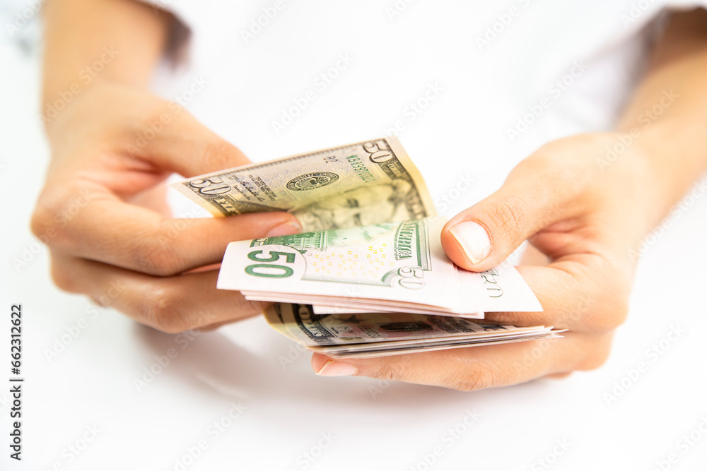 Close up of someone hands holding and counting American dollar banknotes in her hand. Close up of someone hands holding and counting American dollar banknotes in her hand.