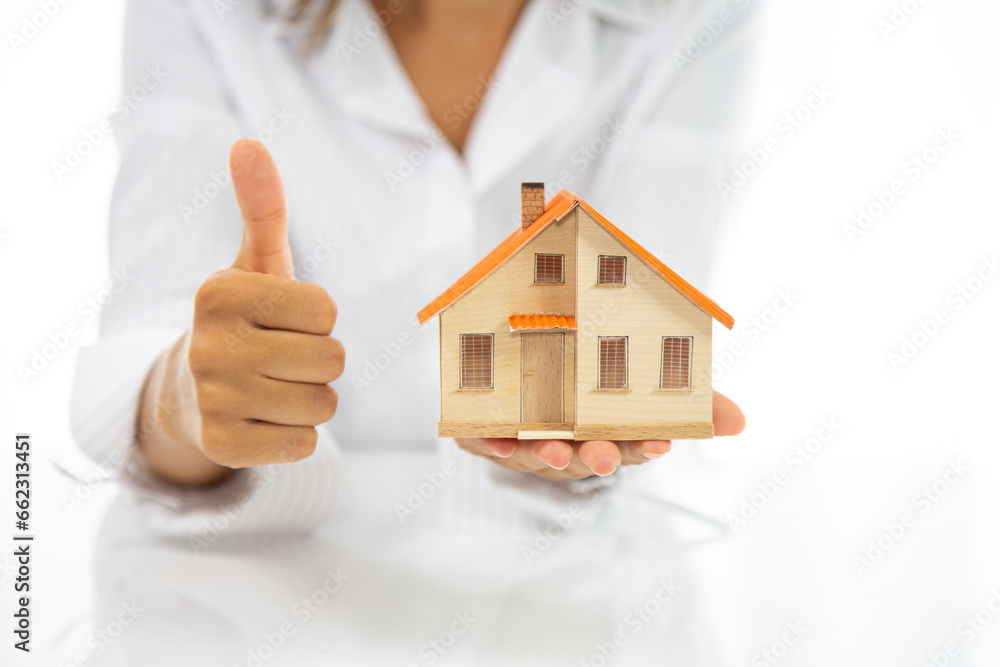 Small toy house in hands. The concept of mortgage lending, real estate insurance, construction, design and sale of residential buildings. Small toy house in hands. The concept of mortgage lending, real estate insurance, construction, design and sale of residential buildings.
