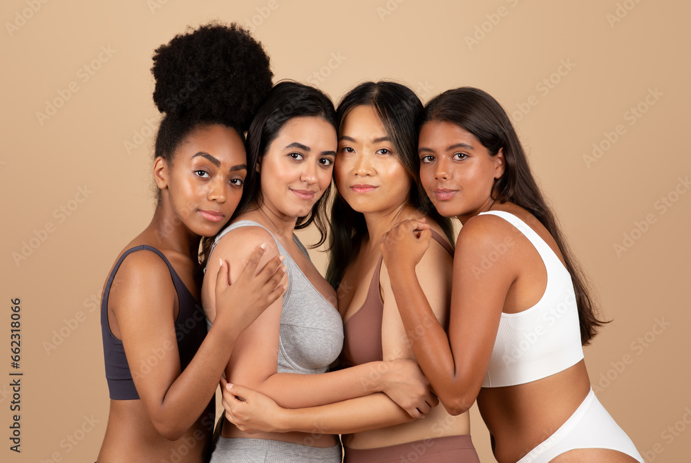 Fototapeta premium Elegant diverse women embracing, posing in underwear