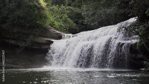 cascada la motilona, beautiful tropical waterfalls in the deep rainforest of the jungle near Paicol in Colombia cascading into a turquoise pool along the riverbed. photo