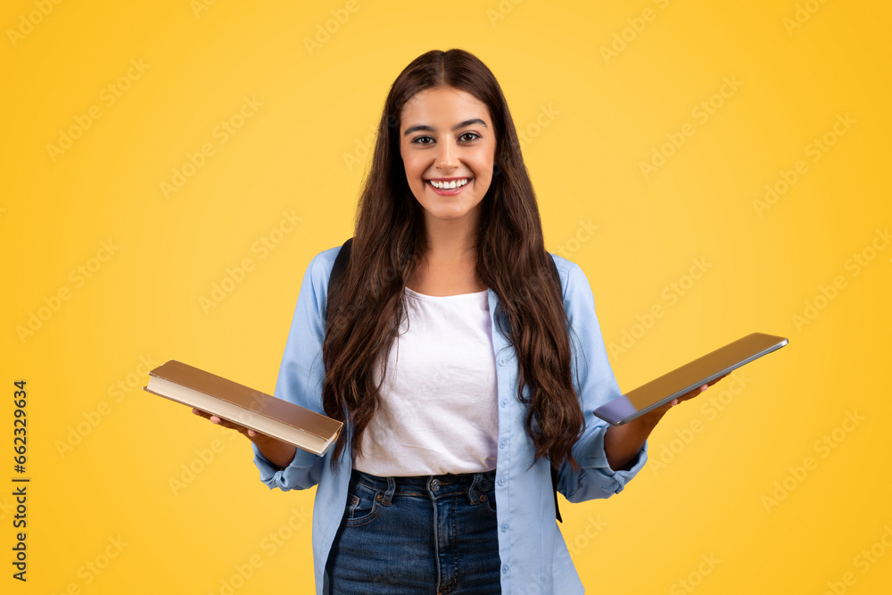 Happy pretty teen student lady hold in hands book and laptop, enjoy study online, learn Happy pretty teen student lady hold in hands book and laptop, enjoy study online, learn