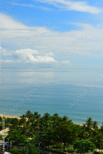 Nha Trang city, Vietnam - October 17, 2023 : overlooking the beautiful coast of Nha Trang with palm trees on the beach 