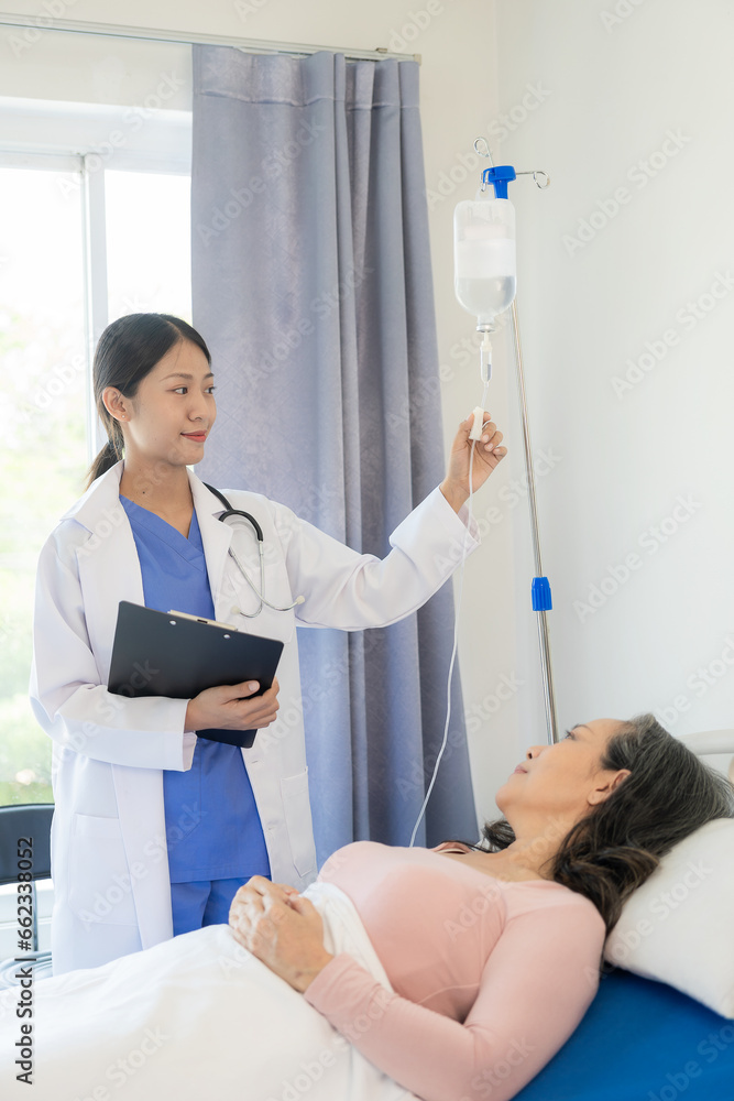Asian female doctor talks to patient with smile to encourage patient at hospital An elderly Asian woman visits a doctor at a hospital office. Talk about the results of the health examination Asian female doctor talks to patient with smile to encourage patient at hospital An elderly Asian woman visits a doctor at a hospital office. Talk about the results of the health examination