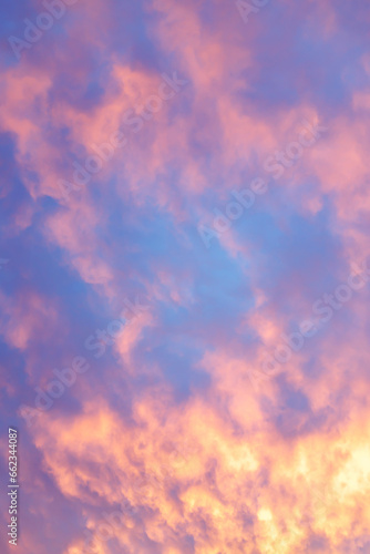 Pink and yellow clouds in sunset blue sky. Sundown natural background