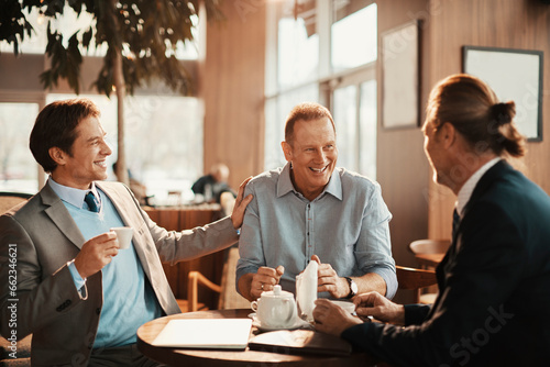 Middle aged business people having a meeting in a cafe decorated for christmas and the new year holidays