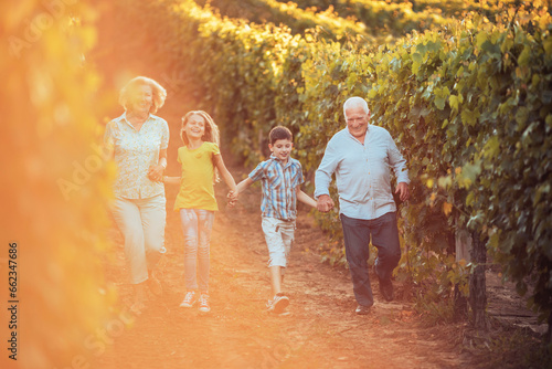 Grandparents giving a tour through the vineyard with their grandchildren