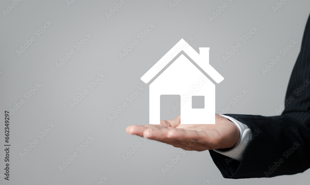 Real estate concept, Businessman showing house icon in hand for Property insurance and security concept. Real estate concept, Businessman showing house icon in hand for Property insurance and security concept.