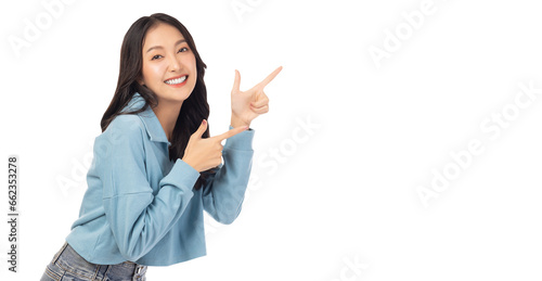 Beautiful young Asian woman pointing up to copy space and looking at camera with smile face and happy Pretty girl act like a satisfied product, use for advertising with isolated on white background