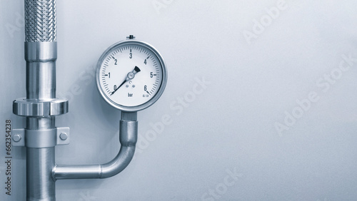 Manometer for measuring pressure on a blue metal background with free space for text, industrial concept background photo
