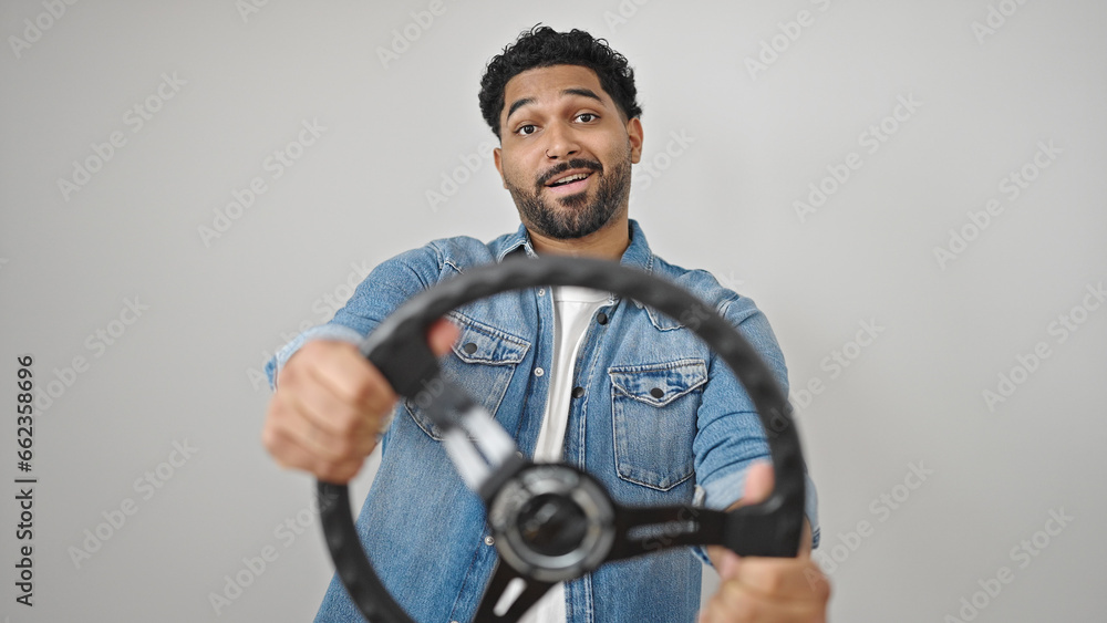 © Krakenimages.com - African american man smiling confident using steering wheel as a driver over isolated white background © Krakenimages.com - African american man smiling confident using steering wheel as a driver over isolated white background