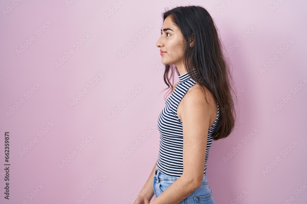 Young teenager girl wearing casual striped t shirt looking to side, relax profile pose with natural face with confident smile. Young teenager girl wearing casual striped t shirt looking to side, relax profile pose with natural face with confident smile.