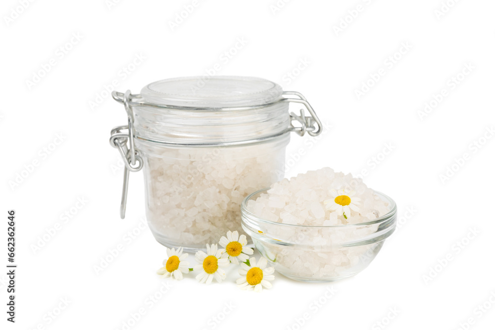 Spa sea salt isolated on white background. Sea salt with chamomile extract in a glass jar on a white background. Spa sea salt isolated on white background. Sea salt with chamomile extract in a glass jar on a white background.